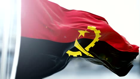 bandera de angola agitando lentamente. agitando la bandera de cerca. bucle sin costuras