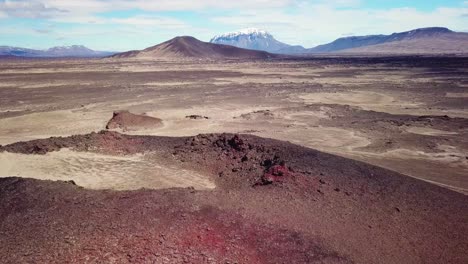 spectacular aerial over red ash topped volcanoes and lava flows in the remote highland interior of iceland 2