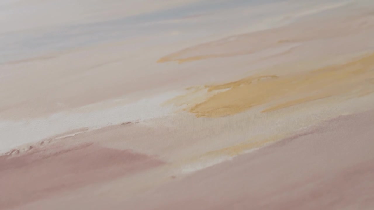 Revealing painted wash on close-up paper with frames advancing, yellow broadening above mauve bands
