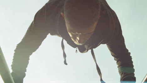 athlete doing handstand on parallel bars