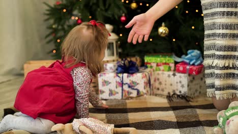 baby girl opens christmas gifts