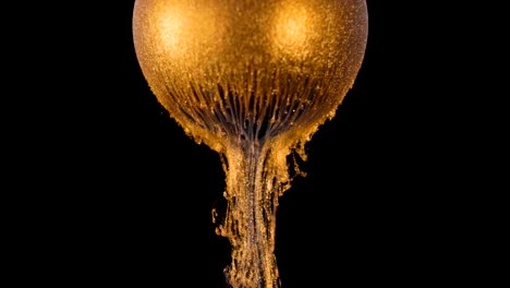 golden shine paint slowly flows from the ball