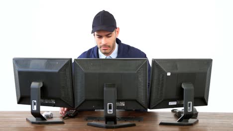 security guard watching cctv footage on computer