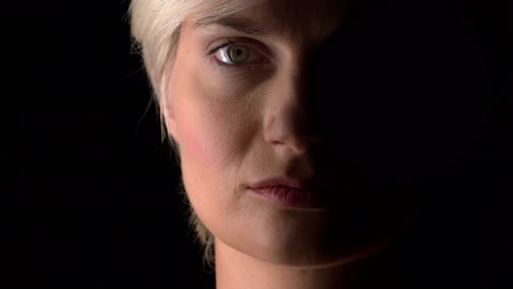 close-up of woman face on dark background