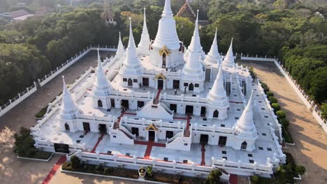 4k drone pans backward above a gorgeous white buddhist temple