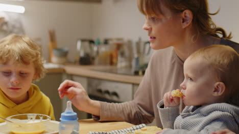 mother having meal with children at home