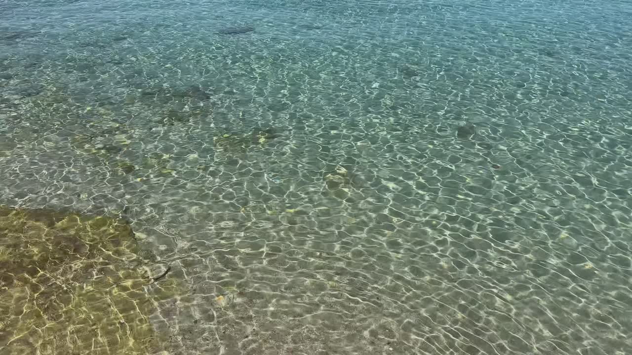 Stunning beach scene in Halkidiki, Greece, with elegant sunbeds facing the crystal-clear turquoise sea. A perfect summer escape in the heart of the Aegean.