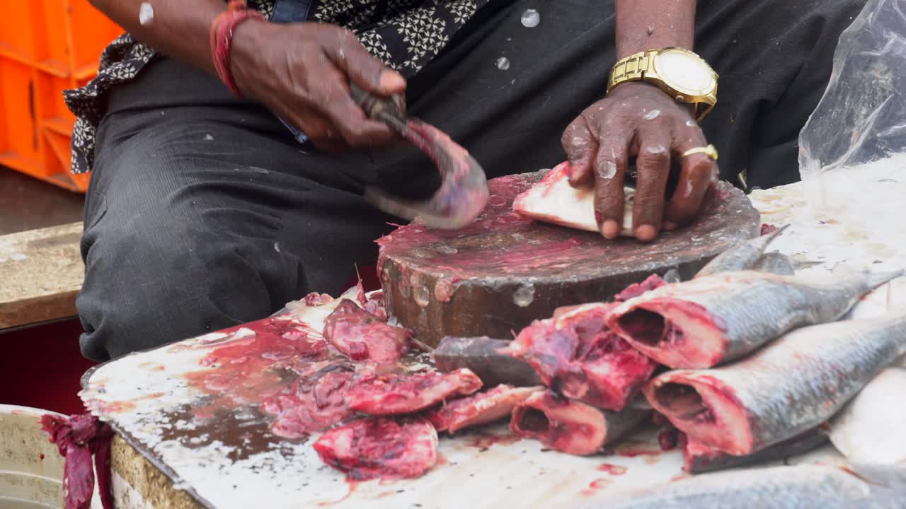 A fisherman is cutting and cleaning the fish close-up shot.USP