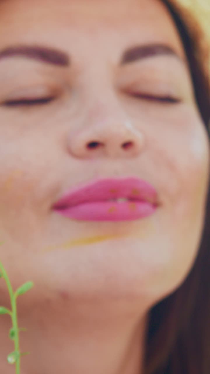 A Serene Moment Captured: Close-Up Portrait of a Woman in Nature, Embracing Joy and Tranquility with a Beautiful Hat Against a Lush Green Background