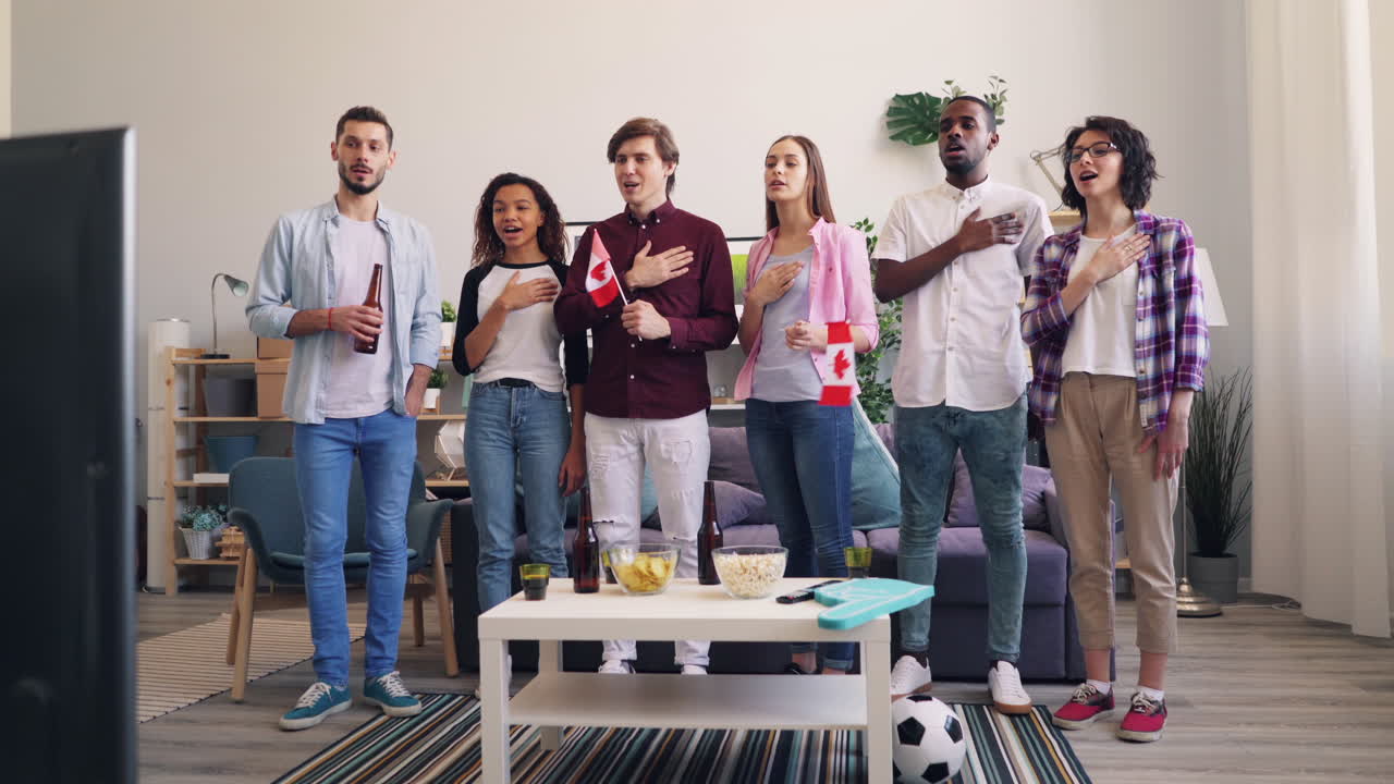 Friends Watching a Game and Singing National Anthem
