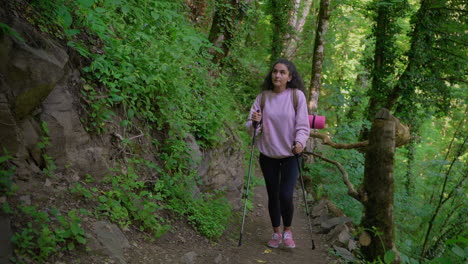 woman hiking in a forest trail