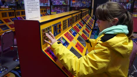 girl playing prize bingo in an arcade