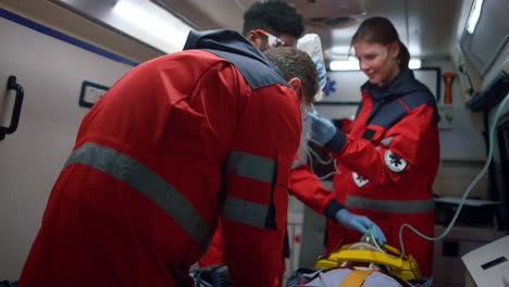 multiethnic paramedics rescuing patient in ambulance car