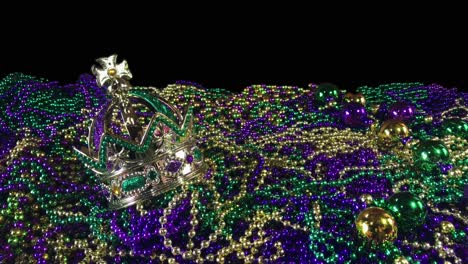 Shining-glitter-crown-on-huge-pile-of-Mardi-Gras-beads-with-copy-space