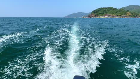 motor boat trail in ocean water on a sunny day, goa india 4k