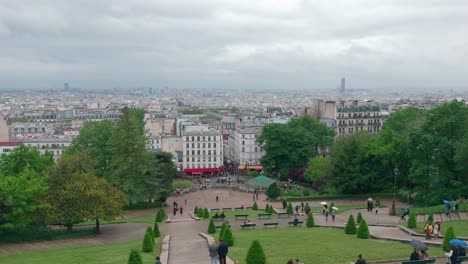 panoramic cityscape of paris seen from steps to montmartre hill
