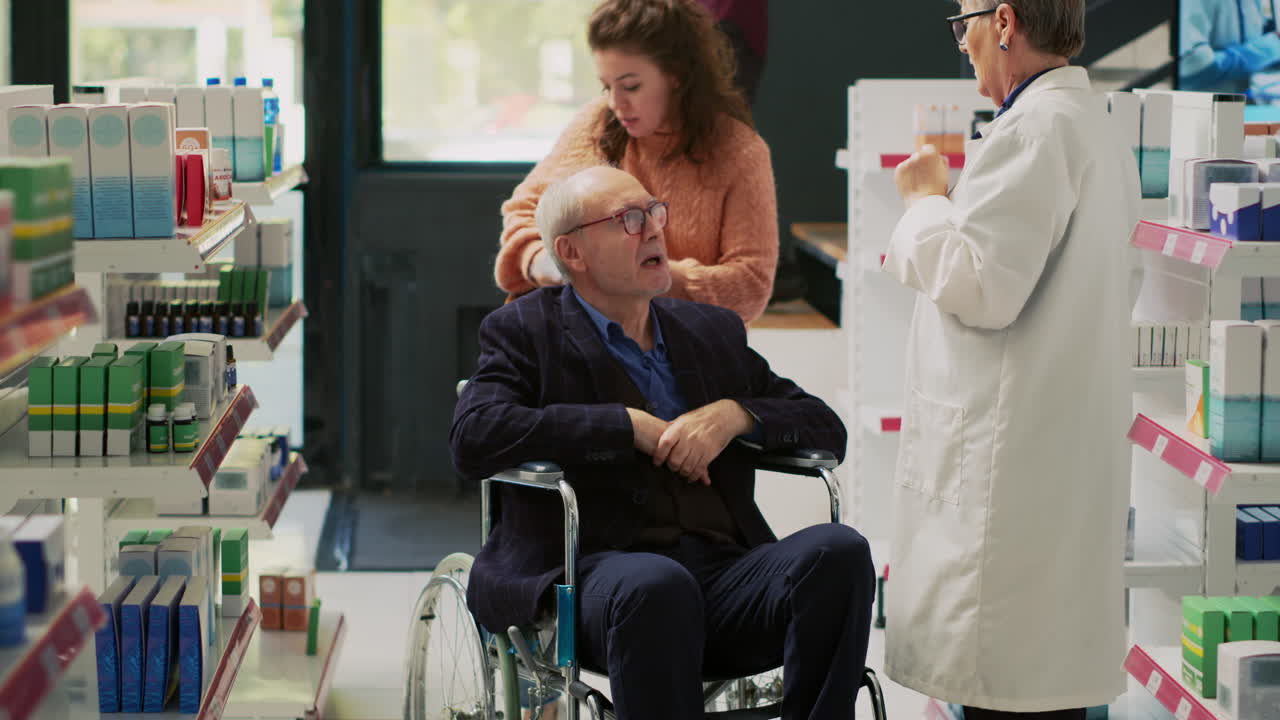 Elderly Man in Wheelchair Receiving Assistance at Pharmacy