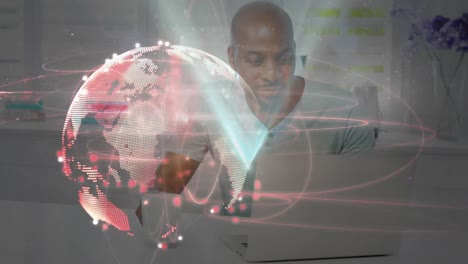 animation of globe with network of connections over man using laptop