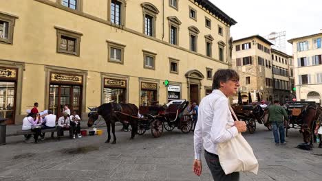 carriages and people in florence, italy