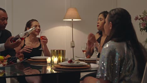 friends enjoying a dinner party with drinks and conversation