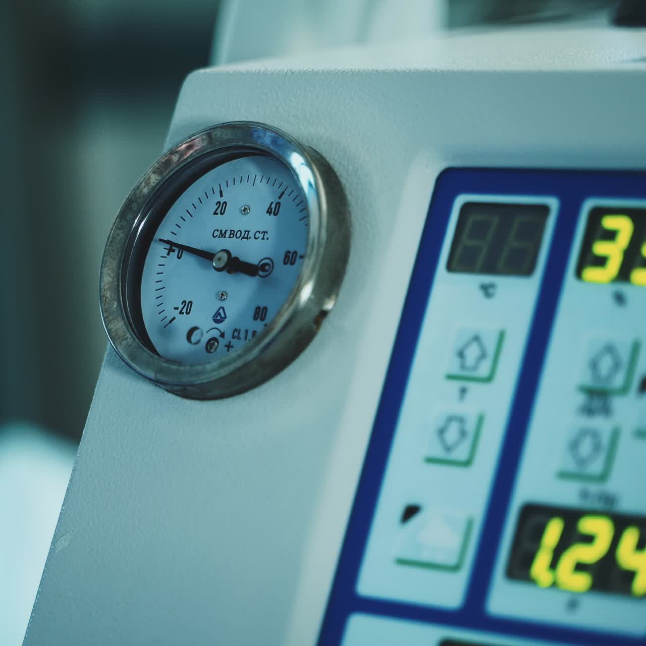 Apparatus with a clockface and electronic screens showing diverse figures. Close up. Equipment in modern operational room
