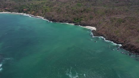 Aerial-drone-shot-of-the-coastline-sea,-white-beach-and-jungle-in-Panama