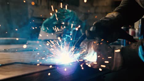 welder on the table welds a set of metal parts