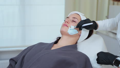 woman receiving facial treatment