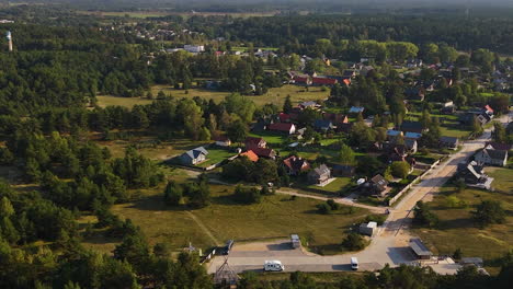 drone shot of pavilosta, latvia, highlighting its peaceful homes and natural beauty.