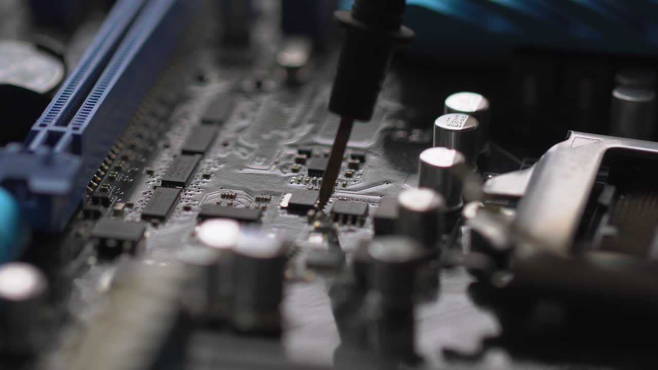 Close-up view of a computer motherboard being repaired or assembled.