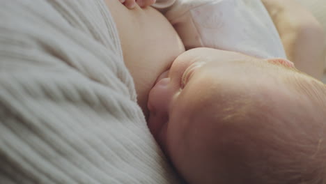 mother breastfeeding newborn baby