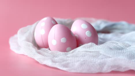 pink easter eggs on a white fabric