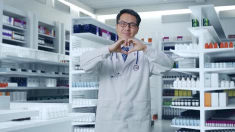 doctor in pharmacy making a heart shape with hands