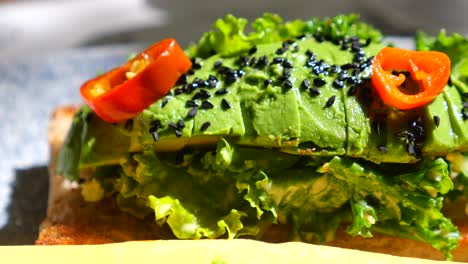 avocado toast with chili peppers and sesame seeds