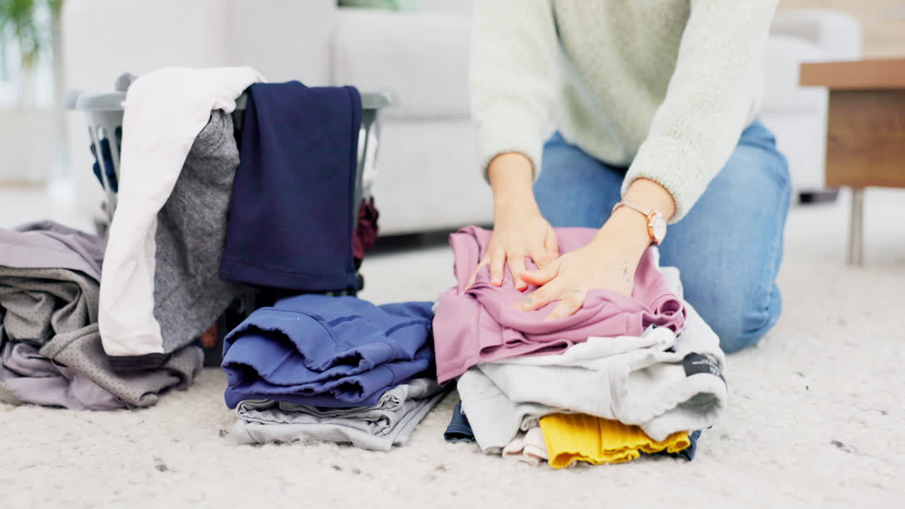 Fold, laundry and hands on clean clothes pile