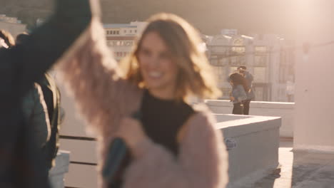 happy young multiracial couple dancing on rooftop at sunset celebrating relationship having fun enjoying playful dance party together