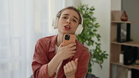 teenage girl singing and recording video