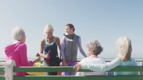 athletic women discussing on the beach