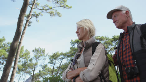 Side-view-of-active-senior-couple-in-forest