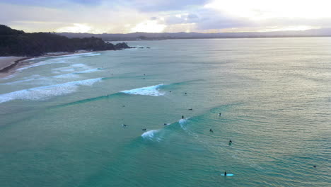 drone of surfers at sunset at wategos beach byron bay australia