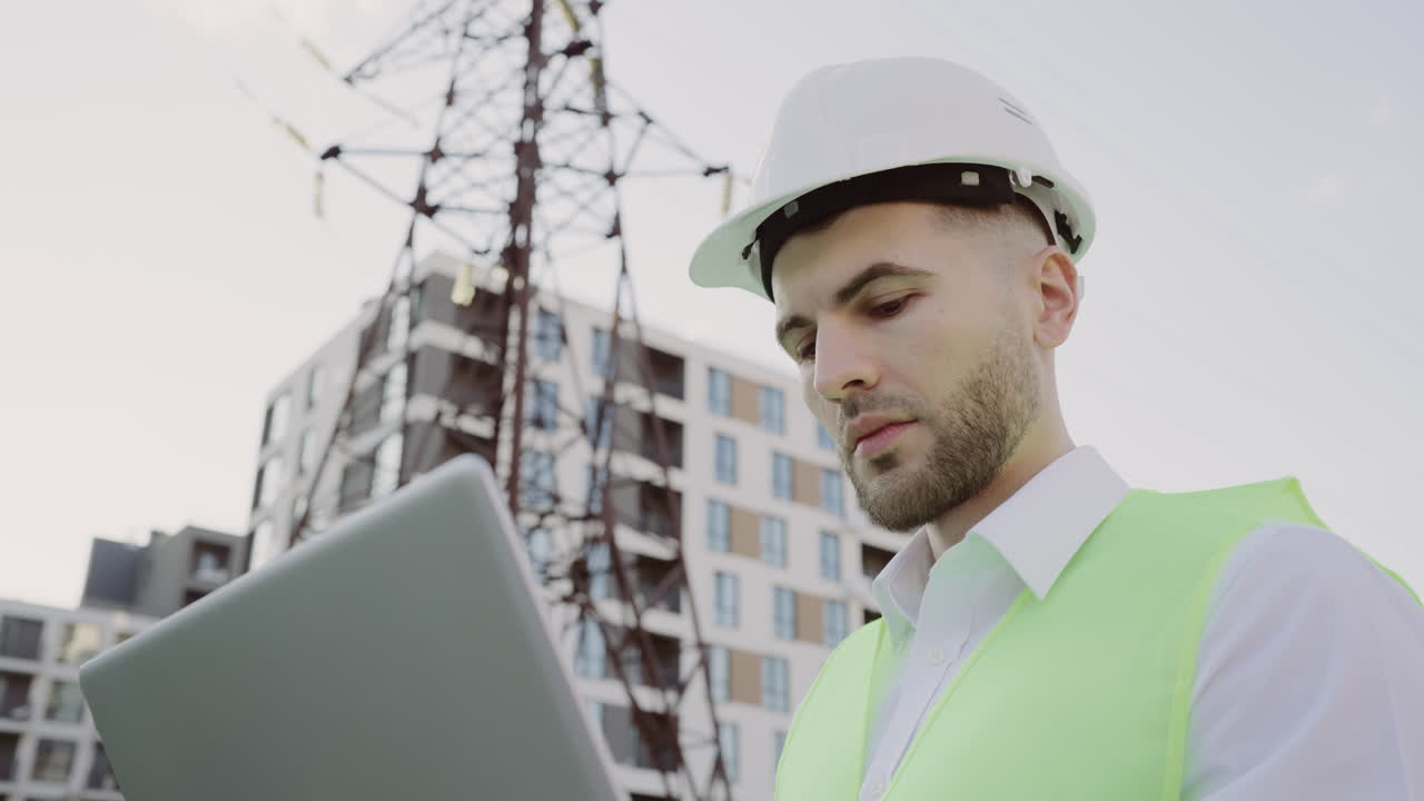 Engineer using a laptop at a construction site