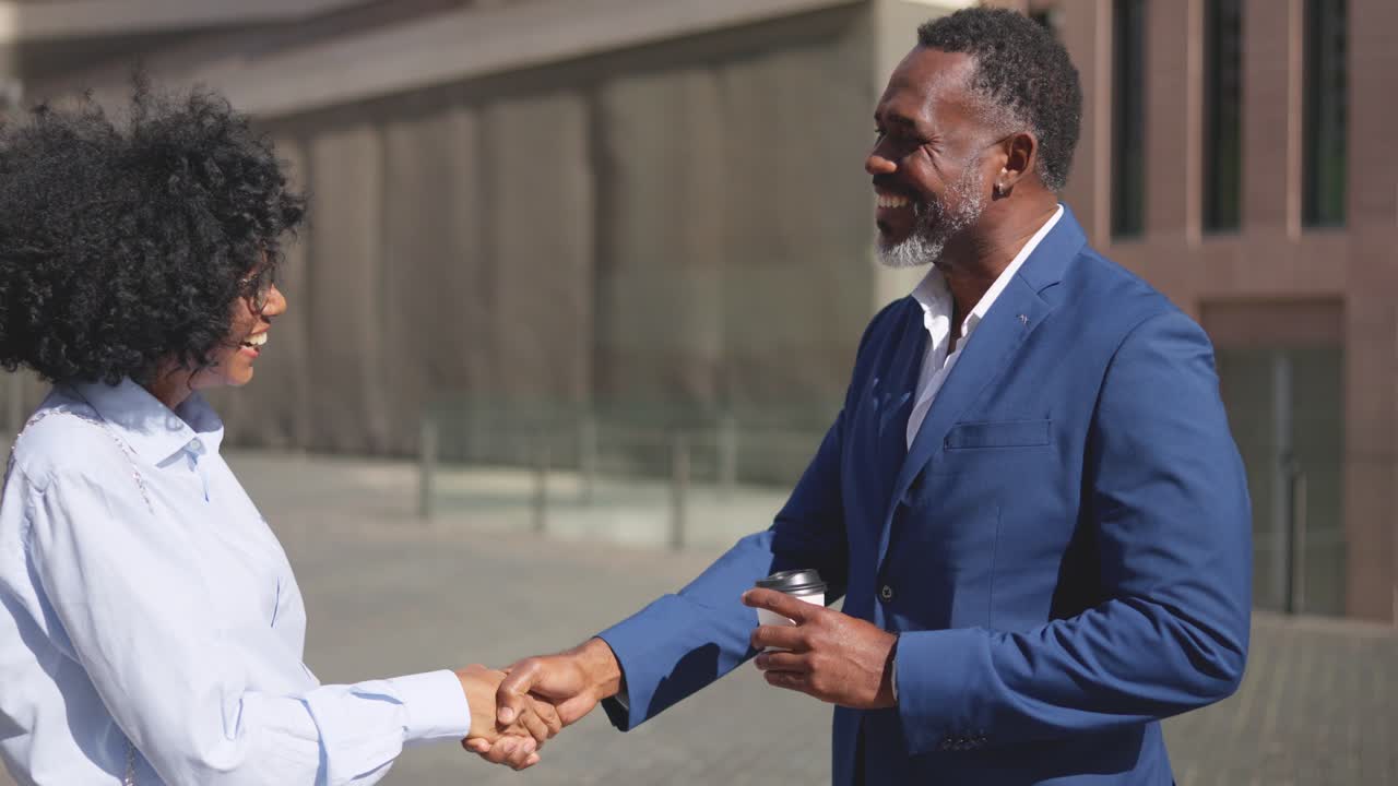 Close-up of two african business people shaking hands outdoors