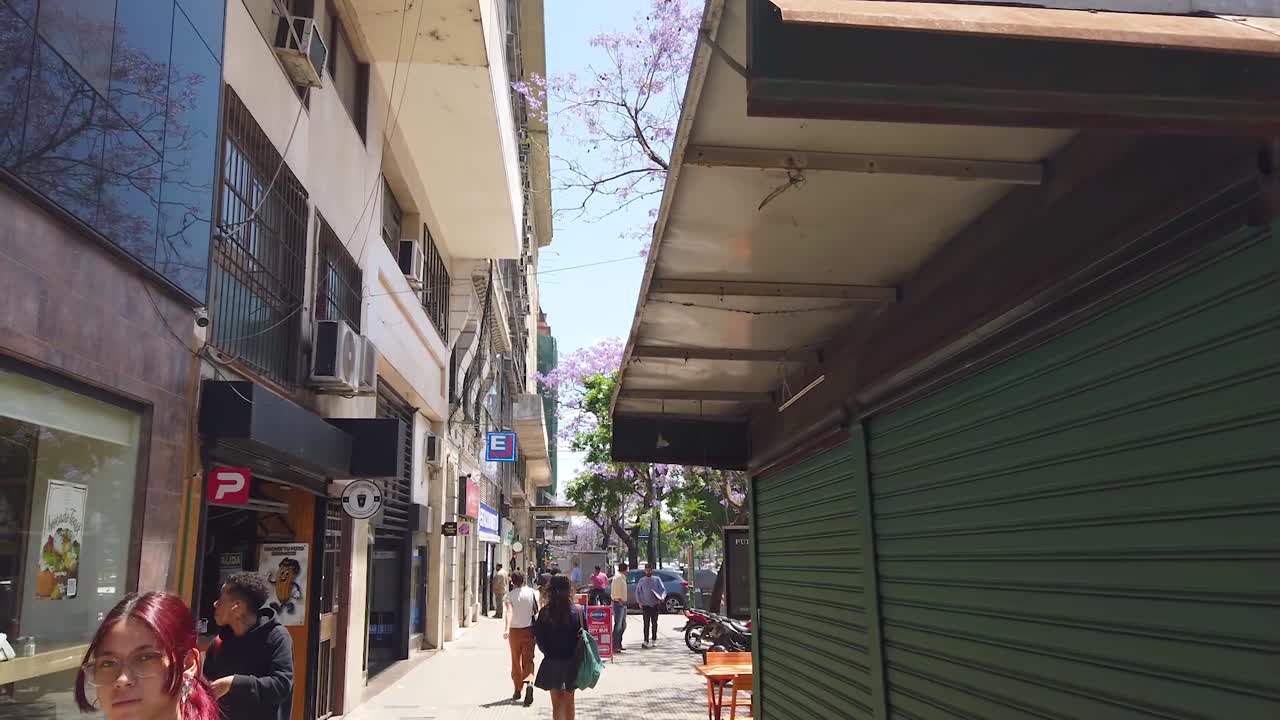 Walking POV at Buenos aires city in Spring, 9 de Julio avenue, people traffic in downtown