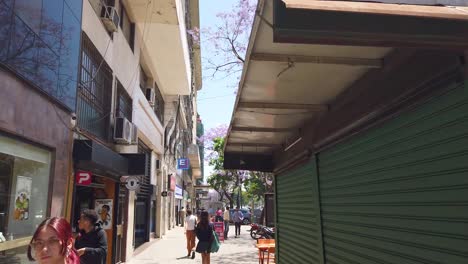 walking pov at buenos aires city in spring, 9 de julio avenue, people traffic in downtown