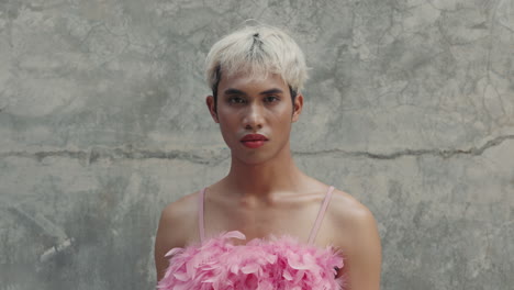 transgender man in pink feather dress