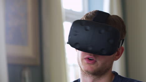 Man-At-Home-Wearing-Virtual-Reality-Headset-Shot-On-R3D