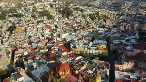 drone reveals guanajuato city center, catholic church, university building, day