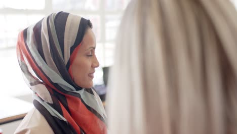 happy diverse business people discussing work with tablet in office in slow motion