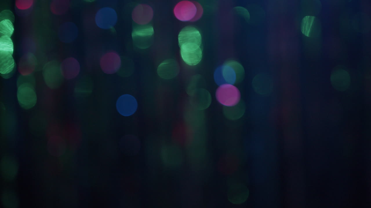 Out of focus curtaing glitters in the neon lights