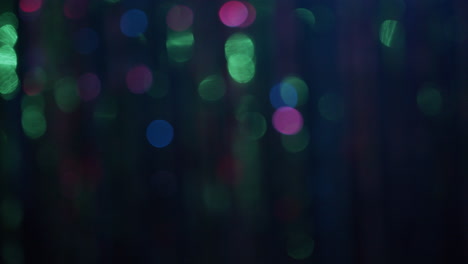 out of focus curtaing glitters in the neon lights